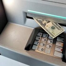 ATM Locations - Photo of an ATM machine dispensing a $20 bill